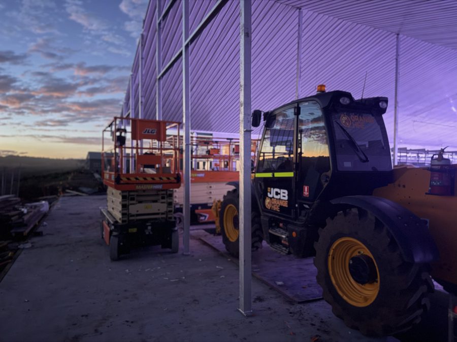 Building exterior at dusk with site machinery